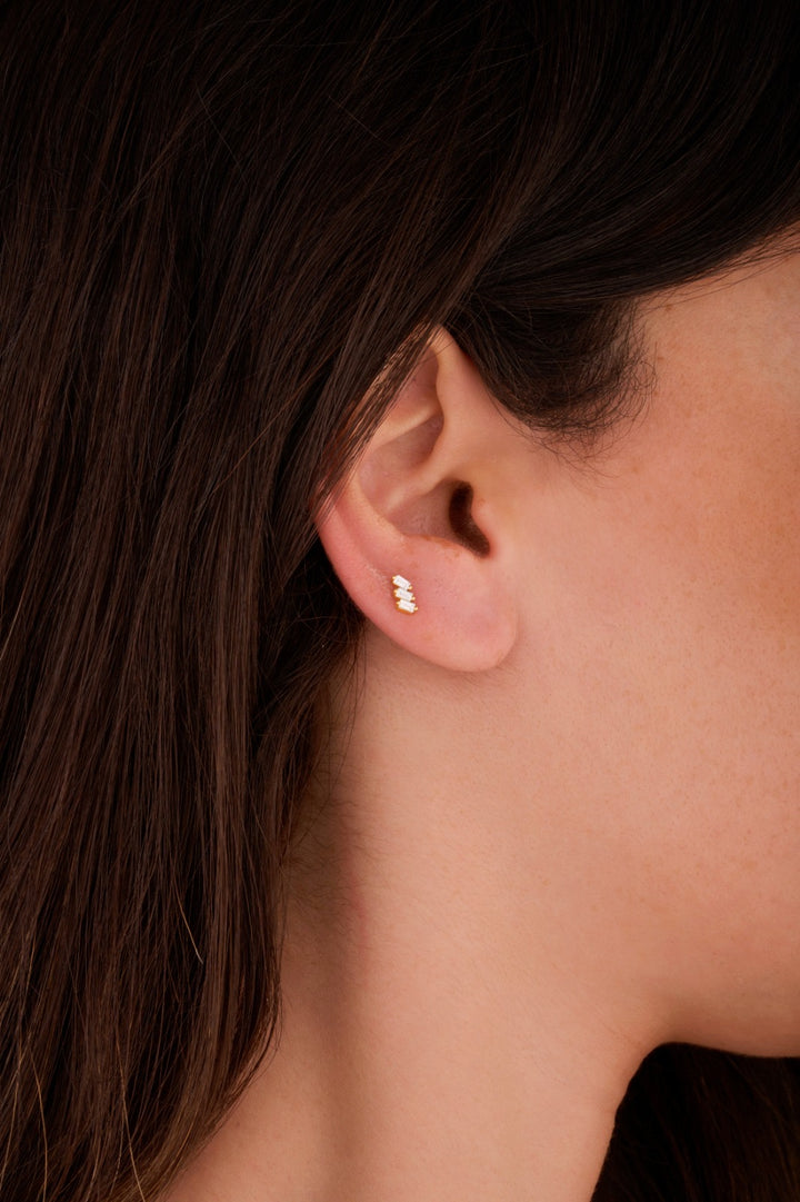 Iris three tiny rectangles gold ear piercing