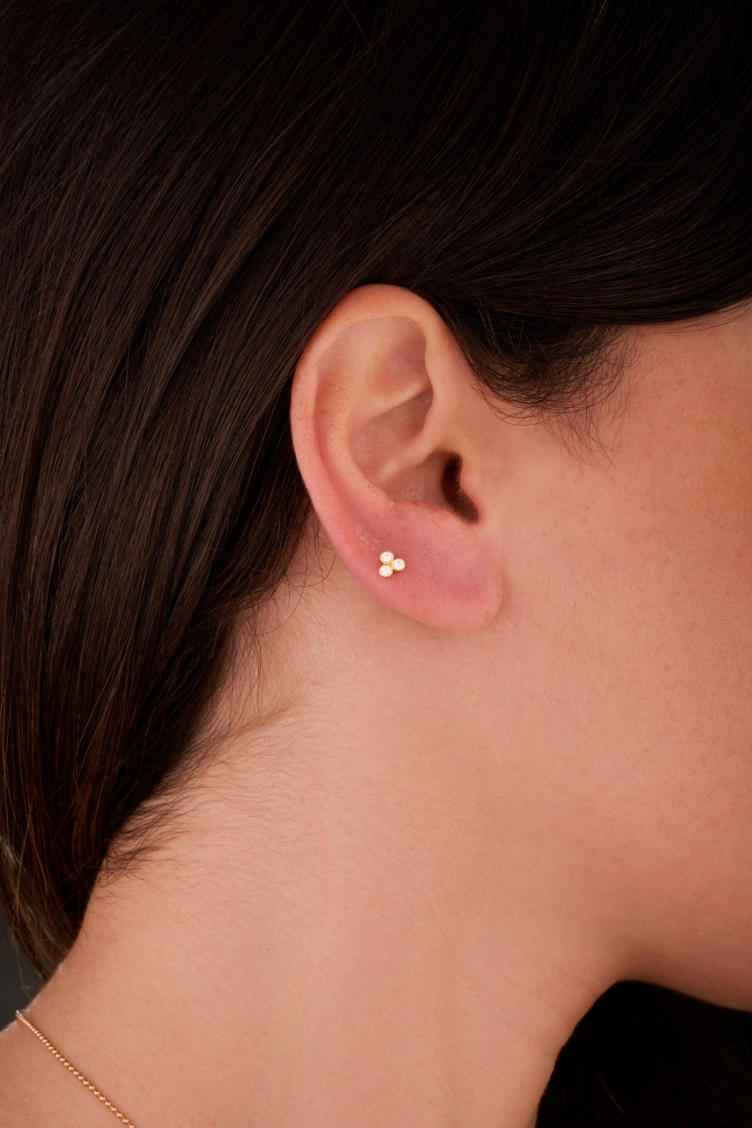 Iris three tiny circles ear piercing