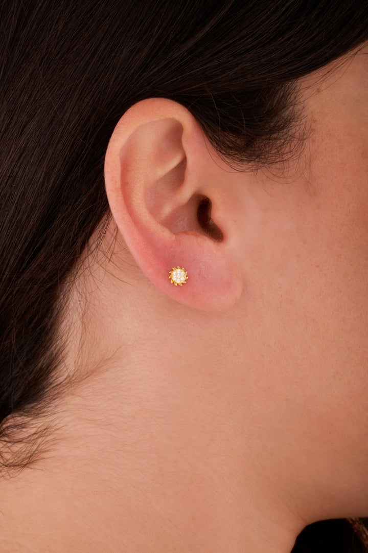 Iris sun stone gold ear piercing