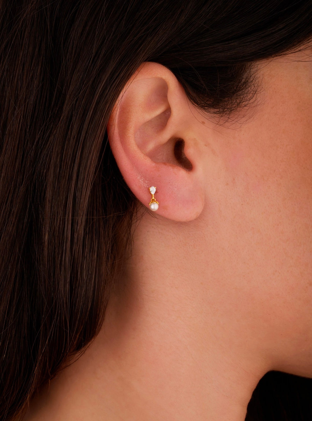 Iris tiny pearl gold ear piercing