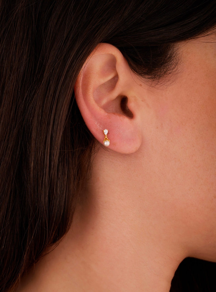 Iris tiny pearl gold ear piercing