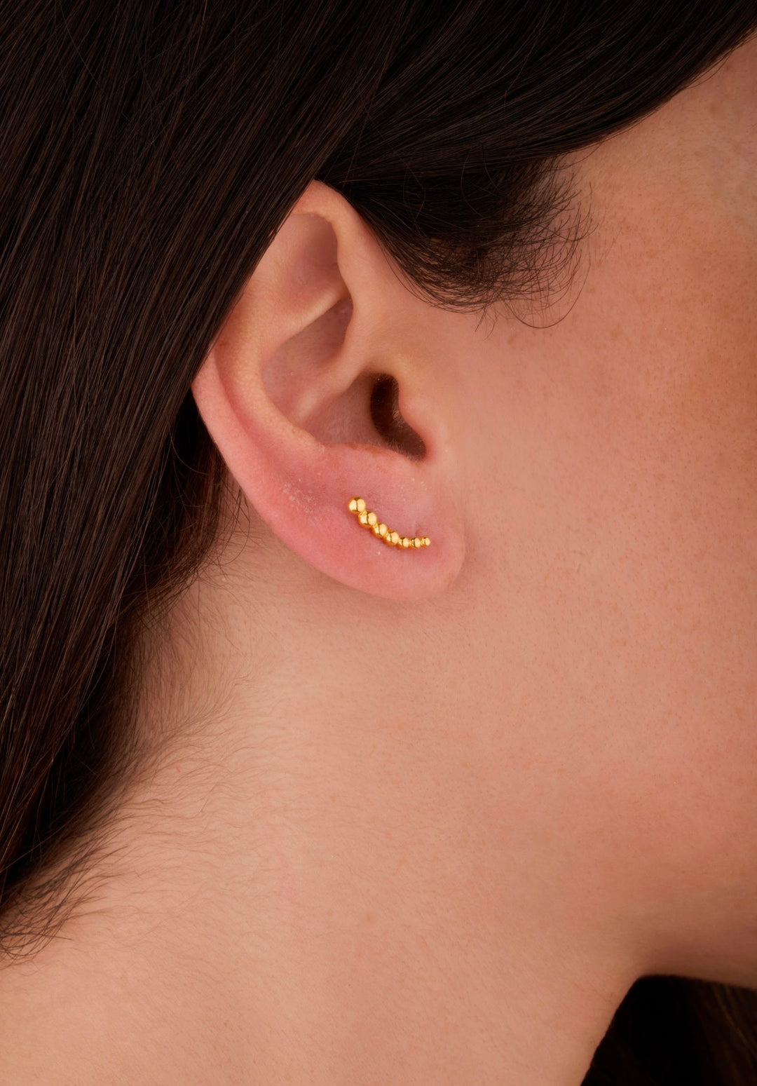 Iris gold ear piercing