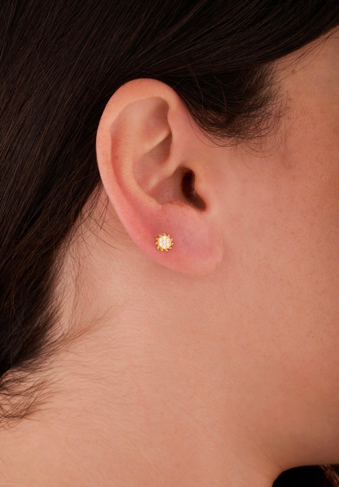Iris sun stone gold ear piercing