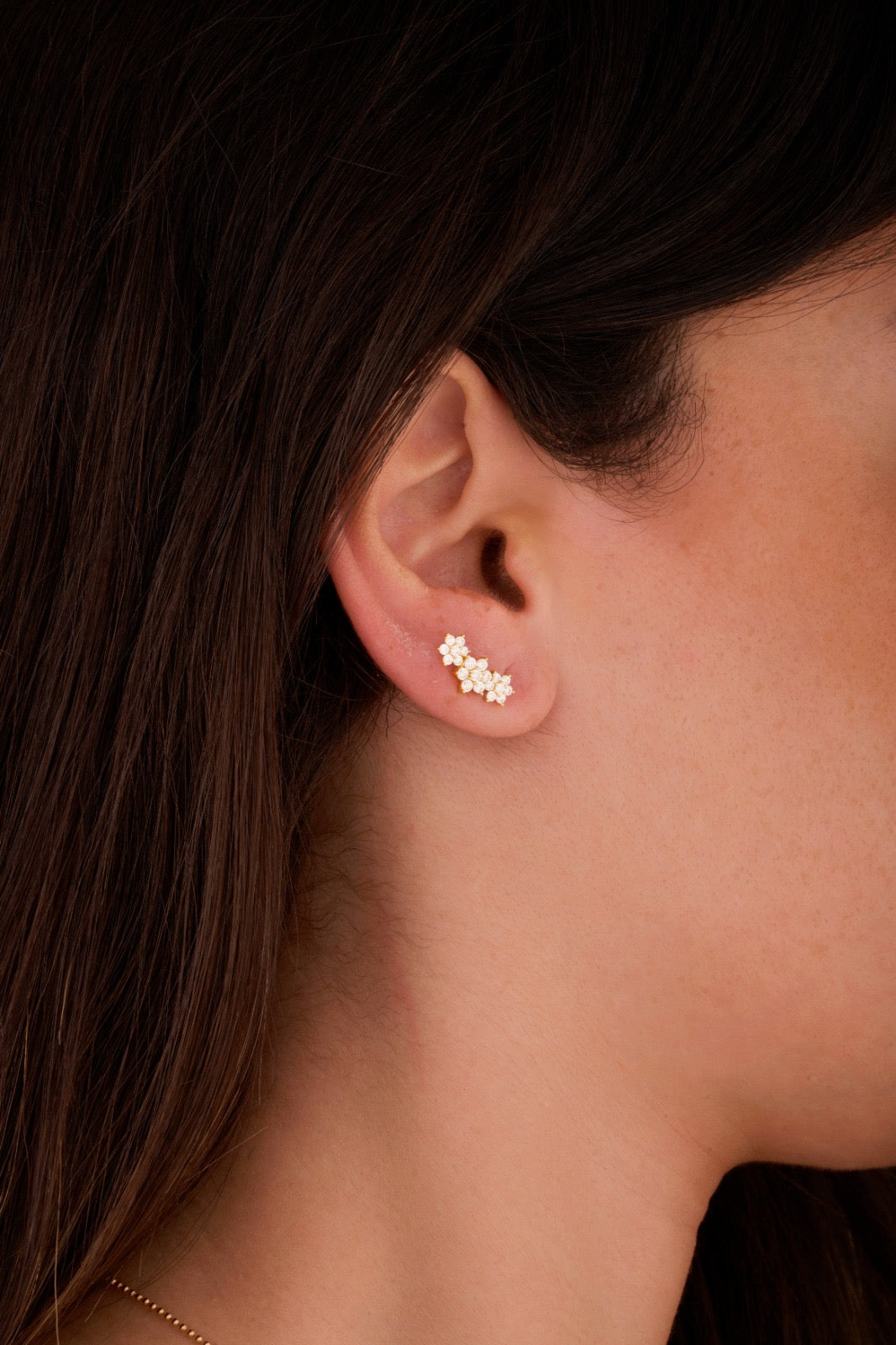 Iris three snowflakes gold ear piercing
