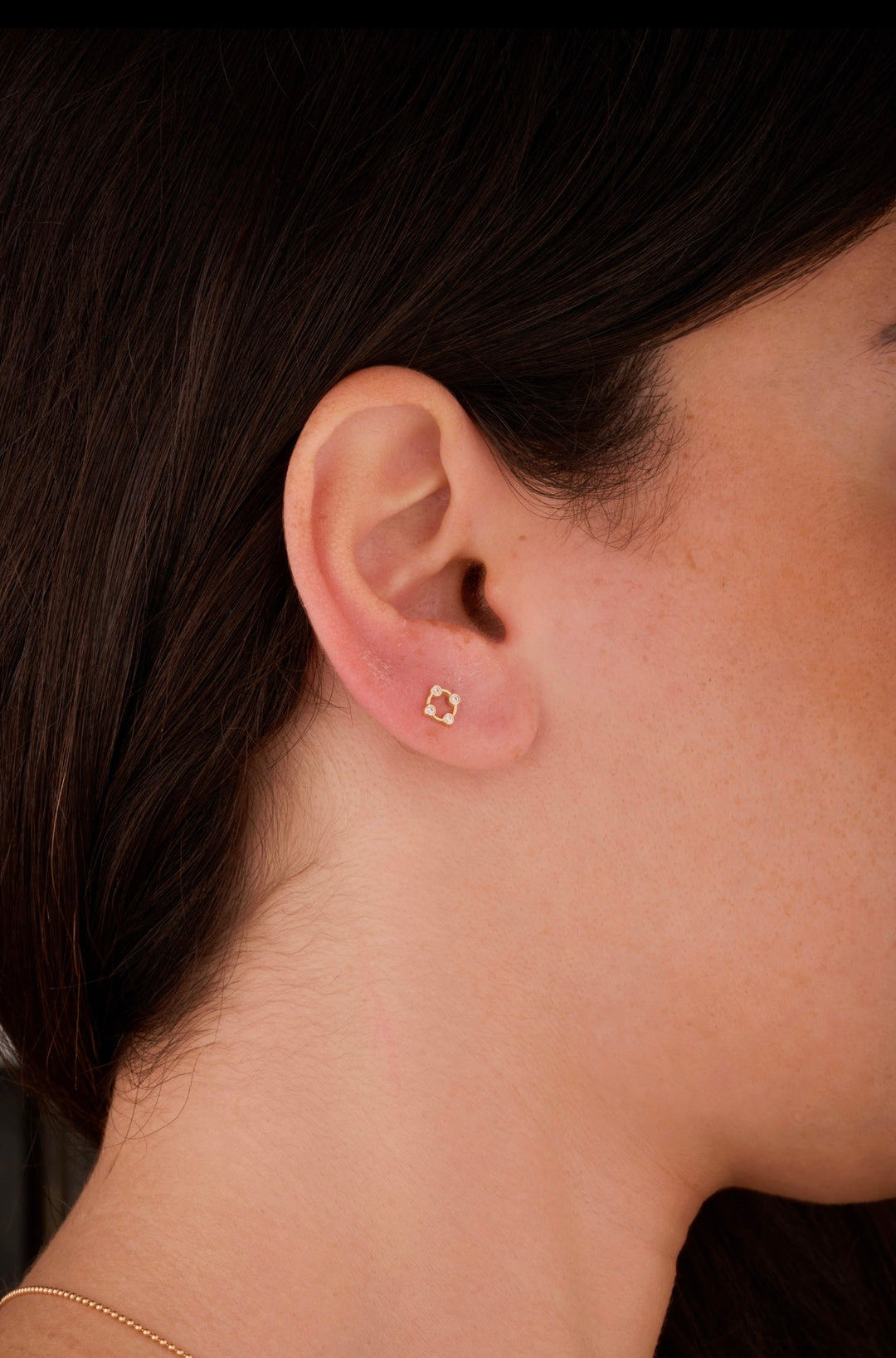 Iris gold ear piercing